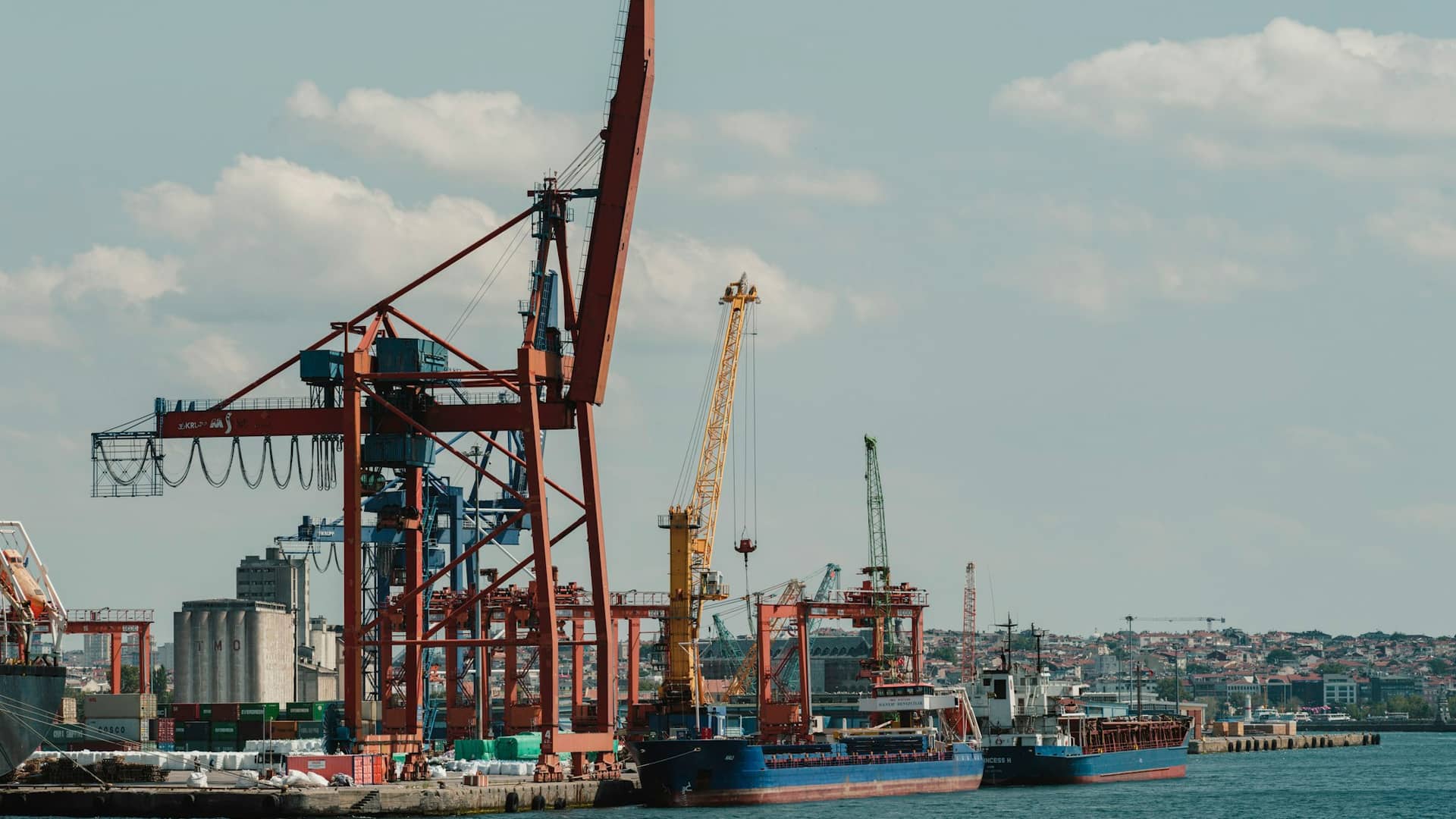Cranes and cargo ships at a port on the Istanbul waterfront